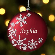 a red ornament with white snowflakes on it