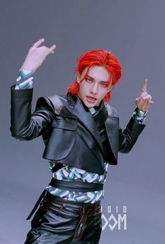 a man with red hair is dressed in black leather