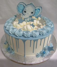 a blue and white cake with an elephant on top