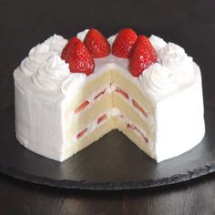 a cake with white frosting and strawberries on top