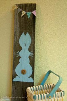 a wooden sign with a bunny painted on it