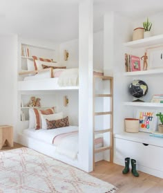 a bedroom with bunk beds and lots of shelves