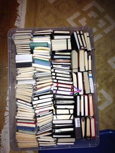 a plastic container filled with lots of books