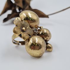 "An antique gold statement ring with a flower among the rough rocks hammered ring to all your outdoor adventures, or a night out in the city. It's so versatile! Very light and comfortable despite the impressive appearance THE DETAILS: ❆ This ring is ADJUSTABLE and fits ALL SIZES! ❆ Pendant Width: 1.8\" (5 CM) ❆ Pendant Width: 1.5\" (4 CM) ❆ Weight 14 gram https://www.etsy.com/listing/771525436 Welcome to my REOPEN Etsy shop I opened my Etsy shop 4 years ago but unfortunately, I couldn't handle i Handmade Elegant Brass Flower Ring, Vintage Adjustable Gold Flower Ring, Adjustable Gold Brass Flower Ring, Antique Hand-cast Brass Rings, Flower-shaped Bronze Brass Jewelry, Round Dangle Earrings, Hammered Ring, Flower Vintage, Hammered Brass