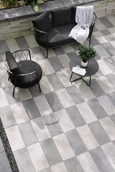 an aerial view of a patio with two chairs and a coffee table on the ground