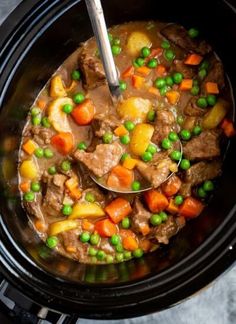 a slow cooker filled with meat and vegetables