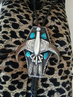 "A large Sterling silver native American turquoise large Thunderbird bolo. This artist made stunning unique bolo weighs 175.5 grams and measures 5\" long and 4\" at the widest point. The center of the thunderbird is mother of pearl (shell) and the beke is coral. The beautiful natural larger turquoise measures approx 16mm and smaller ones approx13mm. This piece is a old pawn bolo from the 50's-60's or could be earlier and is in excellent condition. The wing portion is claw. This bolo is a beautif Handmade Silver Bohemian Bolo Ties, Bohemian Silver Handmade Bolo Tie, Western Style Concho Bolo Ties For Festivals, Silver Western Bolo Ties For Festival, Silver Bohemian Bolo Tie For Western-themed Events, Silver Bohemian Bolo Ties For Western-themed Events, Bohemian Silver Bolo Ties For Western-themed Events, Southwestern Silver Bolo Tie For Rodeo, Southwestern Silver Bolo Ties For Rodeo