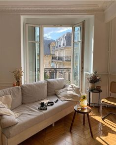 a living room filled with furniture and windows