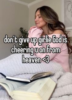 a woman laying on top of a bed with an open book in her lap and the words don't give up girlie god is cheering u on from heaven heaven