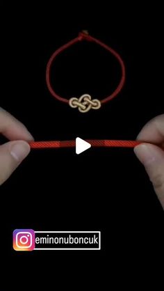 two hands holding a red string with an interlocked knot on it and the word love written in russian