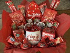 a coffee mug filled with candy and candies on top of a red wrapper