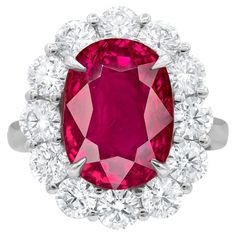 Crafted with meticulous attention to detail, this exquisite natural Ruby gemstone hails from the legendary mines of Mogok, Burma. Its captivating beauty is showcased within a bespoke, handcrafted setting made of solid platinum. The ring's design is elevated with a dazzling halo of round diamonds, meticulously selected and expertly set to accentuate the splendor of the central Ruby. These diamonds collectively weigh 2 carats, adding an enchanting brilliance to the piece. The Ruby itself boasts an Luxury Hallmarked Platinum Ruby Ring, Luxury Antique Oval Cabochon Ruby Ring, Luxury Oval Ruby Diamond Ring, Exquisite Oval Ruby Ring Gia Certified, Luxury Oval Ruby Ring With Prong Setting, Luxury Oval Platinum Gemstones, Exquisite Oval Platinum Gemstones, Luxury Oval Ruby Ring With Halo Design, Oval Cluster Ring With Gemstone In Platinum