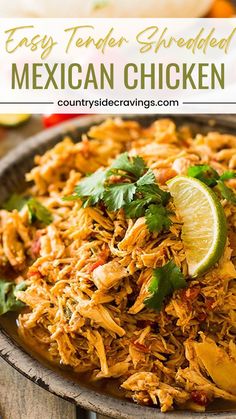 shredded mexican chicken in a bowl with limes and cilantro on the side