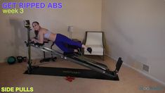 a woman is doing an exercise on a rowing machine in her living room with the caption get ripped abs week 3