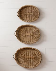 three wicker baskets hanging on the wall