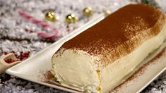 a piece of cake sitting on top of a white plate next to candy canes