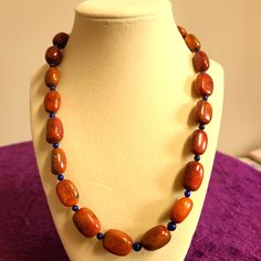 a necklace is on display on a mannequin's neckline with beads