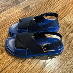 Marni Fussbett Blue Crossover Sandals/Slides Size 39 Hard To Find Size 39 Us 8/8.5 - Cobalt Blue, Black, Gold - Leather -Adjustable Buckle/Strap Chonky And Comfortable Cobalt Blue Leather Fussbett Sandals From Marni Featuring A Sling Back Ankle Strap, An Ankle Strap With Side Buckle Fastening, A Leather Insole, A Molded Leather Footbed And Cross-Ceoss Upper Made In Italy Sole: Rubber 100% Outer: Calf Leather 100% Lining:Leather 100% $Original Price $690 $ No Box Nor Can I Find Price Tag Modern Blue Slip-on Sandals, Blue Slip-on Modern Sandals, Blue Modern Slip-on Sandals, Modern Blue Leather Sandals, Blue Leather Slide Sandals, Modern Blue Slides For Summer, Modern Blue Open Toe Sandals, Designer Blue Leather Sandals, Designer Blue Slides For Summer