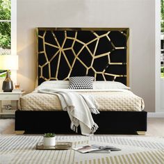 a bedroom with a black headboard and white bedding