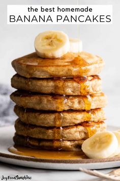 a stack of pancakes with syrup and bananas