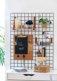 a white desk topped with a blackboard and lots of shelves filled with office supplies