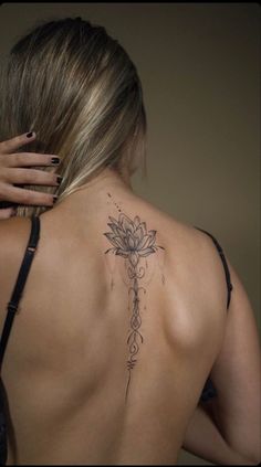 a woman with a cross tattoo on her back