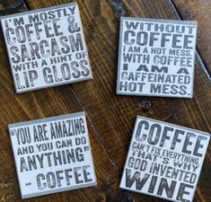 four coasters with words on them sitting on top of a wooden table next to each other