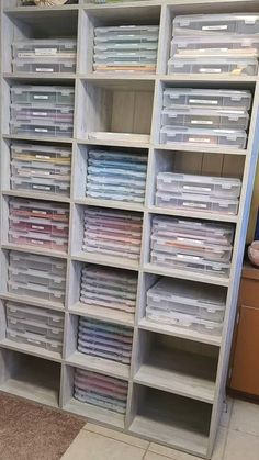 the shelves are filled with many different types of files and folders in bins