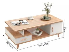 a coffee table with two drawers and a plant on top, next to a magazine rack