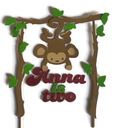 there is a cake topper with a monkey on it and the words annna is two