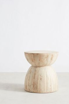 a wooden bowl sitting on top of a table