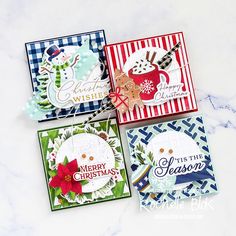 four christmas cards on a marble surface