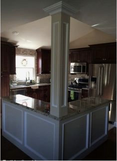 a kitchen with granite counter tops and stainless steel appliances in the middle of the room