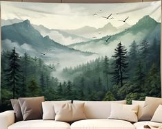 a living room with a couch and large painting on the wall above it that has birds flying in the sky