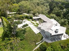 an aerial view of a house surrounded by trees