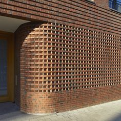 a red brick building with an arched window