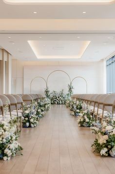 an empty room with rows of chairs and flowers on the floor