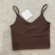 Meshki Willa V Neck Crop Cami Top Chocolate Brown New With Tags! Sold Out Online. Size Extra Small, Super Stretchy! Trendy Brown Camisole Top, Casual Brown Tops With Built-in Bra, Trendy Seamless Brown Tank Top, Brown Seamless V-neck Top, Trendy Brown Cami Top, Brown Top With Built-in Bra For Spring, Casual Brown Cami Crop Top, Trendy Seamless Brown Crop Top, Trendy Brown Seamless Crop Top