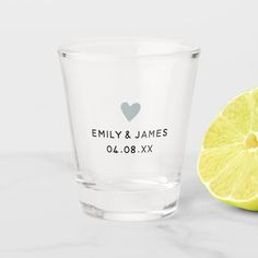 a shot glass next to a lemon on a white countertop with the words, family & james written on it