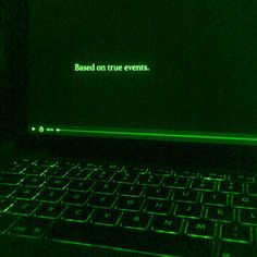 a laptop computer sitting on top of a table in a dark room with the words based on true events