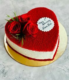 a heart shaped cake with roses on top