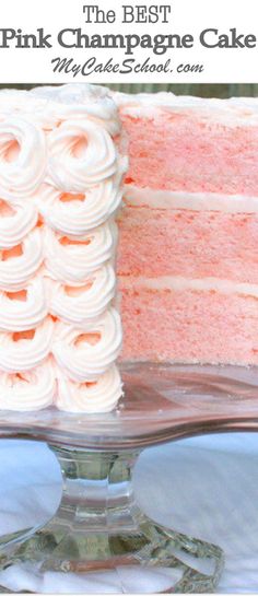 a cake with white frosting on a glass platter that is sitting on a table