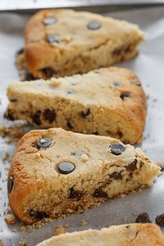 cookies with chocolate chips on them sitting on a baking sheet