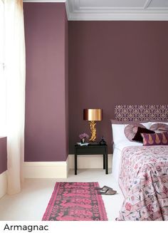 a bedroom with purple walls and white carpet