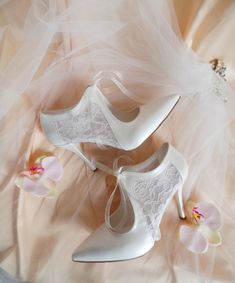 "These romantic bridal shoes feature sheer lace detailing and a vintage style lace-up for a truly unique look.  Handcrafted with floral tulle on the sides, to add a subtle touch of whimsy on your wedding dress.   These elegant heels are perfect for your wedding, but can also be styled on other occasions. Ivory floral tulle lace up wedding shoes for bride, custom heel heights available. Forever keepsake custom wedding gift, personalized wedding shoes. Custom details can be added on this design, the soles can be personalized with your names and wedding date. They are made of soft vegan leather and transparent lace, each handmade item is unique and can differ in details only slightly. Listing shoe style: 3 1/2\" (9cm) heels, closed toes, in ivory.  You can see similar tulle wedding shoes here Elegant Lace Wedding Shoes With Laces, Elegant Wedding Shoes With Laces, Elegant Pointed Toe Wedding Shoes With Laces, Elegant Wedding Heels With Lace Trim, Elegant Heels With Lace Trim, Elegant Heels With Lace Trim And Fitted Design, Elegant Fitted Heels With Lace Trim, Elegant Lace Wedding Shoes, High Heel Wedding Shoes With Lace Trim For Evening