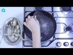 someone is cooking on the stove top with their hand over the pot and frying pan