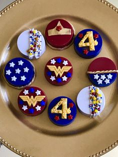 decorated cookies are arranged in the shape of stars and symbols on a gold platter