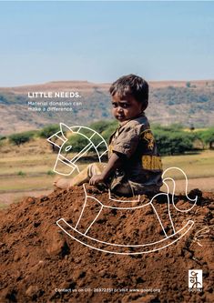 a young boy sitting on top of a pile of dirt with the words little needs