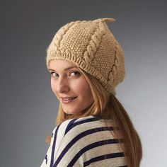 a woman wearing a knitted hat and striped shirt