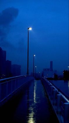 an empty pier at night with the lights on